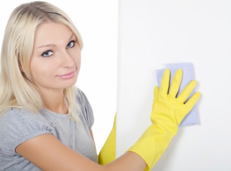 Cleaner wearing PPE during a carpet cleaning task