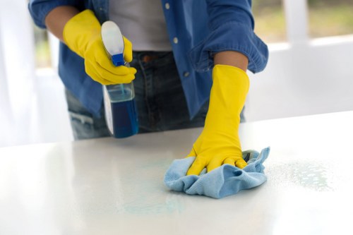Local upholstery technician treating stains on a sofa