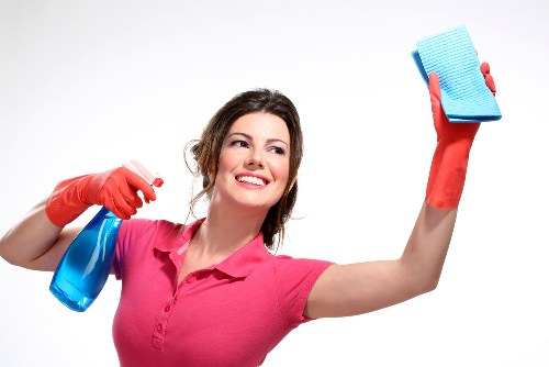 Spot cleaning a sofa in a modern Elephant and Castle apartment